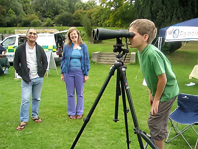 Open Day various stalls. Sue and Jim letting a youngster peek through the large binoculars. 
Link-words: LocalArea HighElms2010