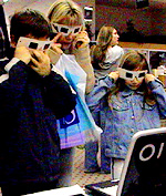 Visitors using coloured goggles to view three dimensional images