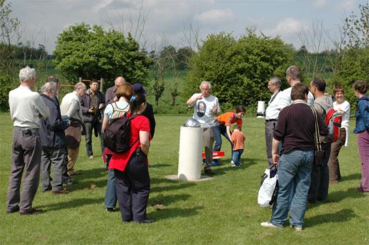 Members gathered round the model's Sun listening to Mr. Thomas