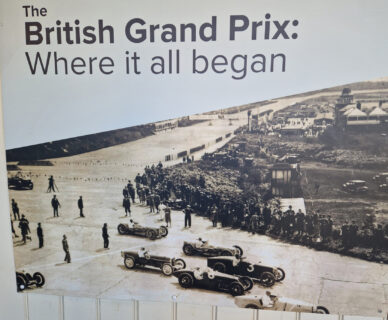 A poster showing Brooklands on a race day